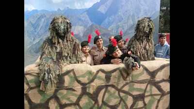 Young NCC cadets pose with the life-size camouflage costumes displayed at the Know Your Army Festival. (Sourced)