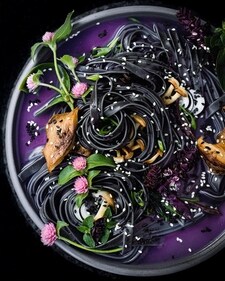 Gluten-free vegan black rice noodles in a purple broth with mushrooms and edible flowers (Instagram) Gluten-free vegan black rice noodles in a purple broth with mushrooms and edible flowers (Instagram)