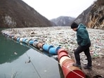 Environmental activist Robert Oroz looks at the floating rubbish dump in the canyon of the Drina river, near the town of Visegrad, Bosnia and Herzegovina. Bosnia: Visegrad's tourism and environment under threat as Drina river becomes a floating dump 