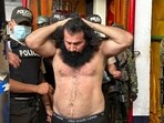 Handout picture released by the Ecuadorean Armed Forces showing Adolfo Macias, aka Fito, leader of the Los Choneros criminal gang, while being transferred to a maximum-security complex in August.