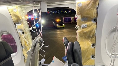Passenger oxygen masks hang from the roof next to a missing window and a portion of a side wall of an Alaska Airlines Flight 1282, which had been bound for Ontario, California and suffered depressurization soon after departing, in Portland, Oregon, US, on January 5, (Instagram/@strawberrvy via REUTERS)