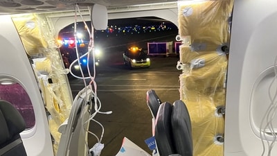 Passenger oxygen masks hang from the roof next to a missing window and a portion of a side wall of an Alaska Airlines Flight 1282, which had been bound for Ontario, California and suffered depressurization soon after departing, in Portland, Oregon, US, on January 5, (Instagram/@strawberrvy via REUTERS)