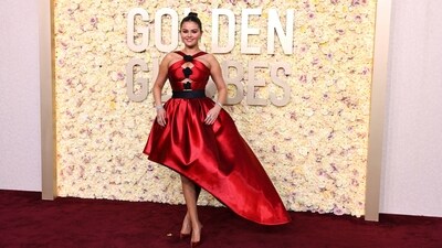 Selena Gomez arrived at the Golden Globes in a stunning shimmering red dress that is sure to capture your heart. She wore a beautiful custom Giorgio Armani Privé ruby red dress featuring black crystal embroidered flowers and an asymmetrical skirt. She styled her look perfectly with ruby red heels, diamond jewellery including staked rings, a sleek bracelet and statement earrings. With her hair tied up in a neat bun and a glowing make-up look, she turned heads. (REUTERS/Mike Blake)