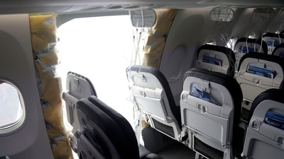 This photo released by the National Transportation Safety Board shows a gaping hole where the paneled-over door had been at the fuselage plug area of Alaska Airlines Flight 1282 on Sunday, Jan. 7, 2024. (National Transportation Safety Board via AP) (AP) This photo released by the National Transportation Safety Board shows a gaping hole where the paneled-over door had been at the fuselage plug area of Alaska Airlines Flight 1282 on Sunday, Jan. 7, 2024. (National Transportation Safety Board via AP) (AP)