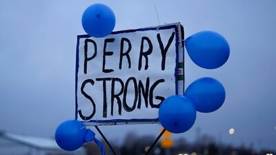 Vehicles are seen in a parking lot outside of Perry High School following a shooting Thursday at the school, Friday, Jan. 5, 2024, in Perry, Iowa (AP Photo/Charlie Neibergall) (AP)
