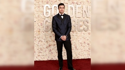 Charles Melton was dressed in a Giorgio Armani Made-to-Measure navy blue double-breasted peak lapel suit and accessorized with an Omega watch. He received a nomination for Supporting Actor in a Motion Picture for his role in “May December.” Charles Melton was dressed in a Giorgio Armani Made-to-Measure navy blue double-breasted peak lapel suit and accessorized with an Omega watch. He received a nomination for Supporting Actor in a Motion Picture for his role in “May December.”