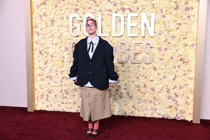 Billie Eilish's cool girl outfit features an oversized blazer, striped shirt and a khaki skirt. (REUTERS)