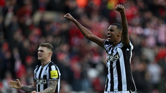 Newcastle United's English defender #02 Kieran Trippier (L) and Newcastle United's Swedish striker #14 Alexander Isak (R) celebrate on the pitch. (AFP)