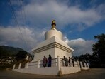 Buddhists walk around a stupa to pray near a polling station on the eve of general election in Deothang in Bhutan on Monday. Buddhists walk around a stupa to pray near a polling station on the eve of general election in Deothang in Bhutan on Monday.