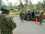 Soldiers check cars during a security operation on the alternative road to the Turi prison, in Cuenca, Ecuador, on January 9, 2024.