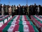 People pray over the flag-draped coffins of victims of Wednesday's bomb explosion during their funeral ceremony in the city of Kerman about 510 miles (820 kms) southeast of the capital Tehran, Iran, Friday, Jan. 5, 2024. Iran on Friday mourned those slain in an Islamic State group-claimed suicide bombing targeting a commemoration for a general slain in a U.S. drone strike in 2020. (AP Photo/Vahid Salemi) People pray over the flag-draped coffins of victims of Wednesday's bomb explosion during their funeral ceremony in the city of Kerman about 510 miles (820 kms) southeast of the capital Tehran, Iran, Friday, Jan. 5, 2024. Iran on Friday mourned those slain in an Islamic State group-claimed suicide bombing targeting a commemoration for a general slain in a U.S. drone strike in 2020. (AP Photo/Vahid Salemi)