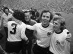 FILE - West German national soccer team captain Franz Beckenbauer, second from right, embraces his team mate, forward Juergen Grabowski after winning the 1974 World Cup