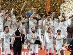 Real Madrid's Karim Benzema celebrates with the trophy and team mates after winning the Copa del Rey 
