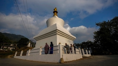 Buddhists walk around a stupa to pray near a polling station on the eve of general election in Deothang in Bhutan on Monday. (AP) Buddhists walk around a stupa to pray near a polling station on the eve of general election in Deothang in Bhutan on Monday. (AP)