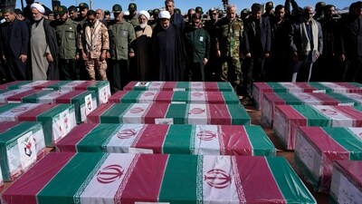People pray over the flag-draped coffins of victims of Wednesday's bomb explosion during their funeral ceremony in the city of Kerman about 510 miles (820 kms) southeast of the capital Tehran, Iran, Friday, Jan. 5, 2024. Iran on Friday mourned those slain in an Islamic State group-claimed suicide bombing targeting a commemoration for a general slain in a U.S. drone strike in 2020. (AP Photo/Vahid Salemi) (AP) People pray over the flag-draped coffins of victims of Wednesday's bomb explosion during their funeral ceremony in the city of Kerman about 510 miles (820 kms) southeast of the capital Tehran, Iran, Friday, Jan. 5, 2024. Iran on Friday mourned those slain in an Islamic State group-claimed suicide bombing targeting a commemoration for a general slain in a U.S. drone strike in 2020. (AP Photo/Vahid Salemi) (AP)