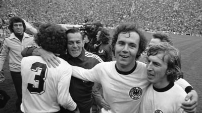 FILE - West German national soccer team captain Franz Beckenbauer, second from right, embraces his team mate, forward Juergen Grabowski after winning the 1974 World Cup (AP) FILE - West German national soccer team captain Franz Beckenbauer, second from right, embraces his team mate, forward Juergen Grabowski after winning the 1974 World Cup (AP)