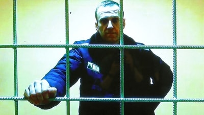 Russian opposition leader Alexei Navalny is seen on a screen via video link from the IK-2 corrective penal colony in Pokrov in May 2022. (Reuters)