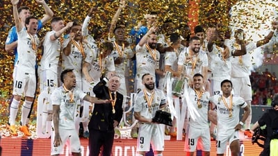 Real Madrid's Karim Benzema celebrates with the trophy and team mates after winning the Copa del Rey (REUTERS)