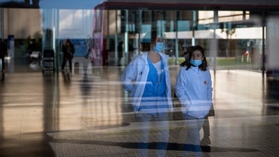 People wearing face masks as a precaution walk inside a hospital in Barcelona (AP) People wearing face masks as a precaution walk inside a hospital in Barcelona (AP)