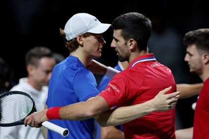 Serbia's Novak Djokovic with Italy's Jannik Sinner after their doubles match (REUTERS)