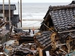People look back toward the collapsed houses in Wajima, Ishikawa prefecture, Japan Wednesday, Jan. 10, 2024. A powerful earthquake slammed the western coastline of Japan on New Year’s Day. (Kyodo News via AP)