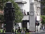 British police officers secure the area around The Cenotaph war memorial on Whitehall in central London. British police officers secure the area around The Cenotaph war memorial on Whitehall in central London.