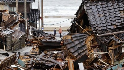 People look back toward the collapsed houses in Wajima, Ishikawa prefecture, Japan Wednesday, Jan. 10, 2024. A powerful earthquake slammed the western coastline of Japan on New Year’s Day. (Kyodo News via AP) (AP) People look back toward the collapsed houses in Wajima, Ishikawa prefecture, Japan Wednesday, Jan. 10, 2024. A powerful earthquake slammed the western coastline of Japan on New Year’s Day. (Kyodo News via AP) (AP)