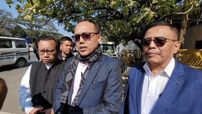 Manipur Congress chief K Meghachandra (middle) addressing media persons after meeting the chief minister. (HT photo)