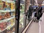 A customer shops for frozen food at a grocery store on December 12, 2023 in San Anselmo, California. A customer shops for frozen food at a grocery store on December 12, 2023 in San Anselmo, California.