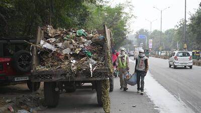 A team of MCG contract workers clean garbage from the MDI Chowk on December 4. (Parveen Kumar/HT Photo) A team of MCG contract workers clean garbage from the MDI Chowk on December 4. (Parveen Kumar/HT Photo)