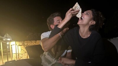 Hrithik Roshan and Deepika Padukone fighting over pizza.
