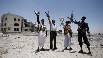 Shiite fighters, known as Houthis, hold up their weapons as they chant slogans at the residence of a military commander of the militant group in Sanaa, Yemen, in 2015. (AP) Shiite fighters, known as Houthis, hold up their weapons as they chant slogans at the residence of a military commander of the militant group in Sanaa, Yemen, in 2015. (AP)