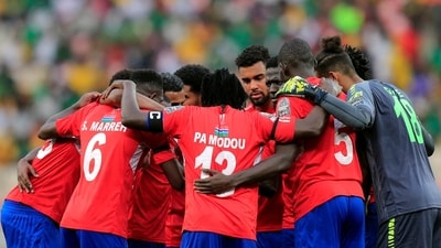 Gambia players huddle before the start of the second half (REUTERS)