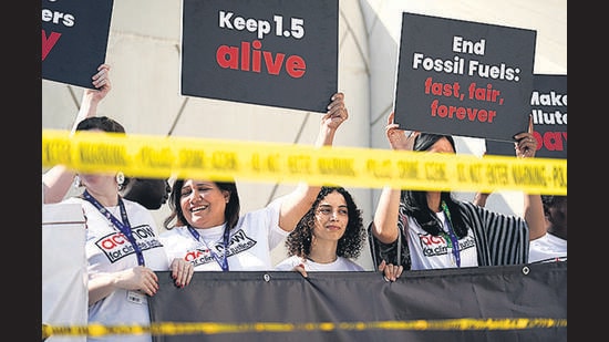 FILE - Activists protest against fossil fuels at the COP28 U.N. Climate Summit, Dec. 5, 2023, in Dubai, United Arab Emirates. Earth last year shattered global annual heat records, the European climate agency said Tuesday, Jan. 9, 2024. (AP Photo/Joshua A. Bickel, File) (AP)