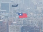 China-Taiwan Conflict: A Chinook helicopter carrying a Taiwan flag flies over the city during the country's National Day celebration in Taipei, Taiwan.