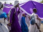 TOPSHOT - Worshippers of the Legio Maria African Church Mission walk in a procession on their way to their Christmas Eve vigil mass in a remote area near Ugunja, on December 24, 2023. Legio Maria is an African independent religious movement that developed gradually and eventually separated from the Roman Catholic Church in the 1960s. The religious movement was initiated by repeated appearances of a mystic woman delivering messages about the incarnation of the Son of God as a black man. (Photo by LUIS TATO / AFP) TOPSHOT - Worshippers of the Legio Maria African Church Mission walk in a procession on their way to their Christmas Eve vigil mass in a remote area near Ugunja, on December 24, 2023. Legio Maria is an African independent religious movement that developed gradually and eventually separated from the Roman Catholic Church in the 1960s. The religious movement was initiated by repeated appearances of a mystic woman delivering messages about the incarnation of the Son of God as a black man. (Photo by LUIS TATO / AFP)