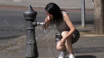 FILE - A woman drinks from a public fountain tap in Madrid, Spain, Aug. 9, 2023. The latest calculations from several science agencies Friday, Jan. 12, 2024, all say that global average temperatures for 2023 shattered existing heat records. (AP) FILE - A woman drinks from a public fountain tap in Madrid, Spain, Aug. 9, 2023. The latest calculations from several science agencies Friday, Jan. 12, 2024, all say that global average temperatures for 2023 shattered existing heat records. (AP)