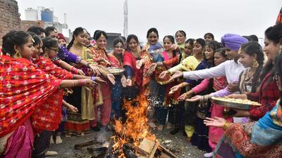 Girls celebrating on the eve of Lohri in Amritsar on Friday. Amritsar was the coldest place in Punjab at a low of 1.4°C. (Sameer Sehgal/HT)