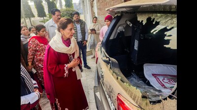 MP Preneet Kaur looks at a damaged car after the residence of BJP leader Seema Sharma was attacked by unidentified people, in Patiala on Friday. (PTI)