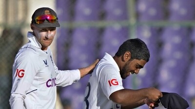 England's Rehan Ahmed, right, is congratulated by teammate Joe Root (AP) England's Rehan Ahmed, right, is congratulated by teammate Joe Root (AP)