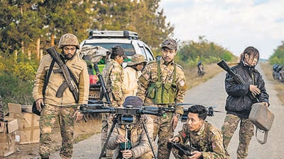TOPSHOT - This photo taken on December 11, 2023 shows members of the Mandalay People’s Defense Forces (MDY-PDF) preparing to release a drone near the frontline amid clashes with Myanmar's military in northern Shan State. A squad of Myanmar pro-democracy fighters works quickly to ready drones for an attack on a nearby military base, the latest target in a wave of aerial assaults that has helped turn the war against the junta. (Photo by AFP) / TO GO WITH Myanmar-coup, FOCUS (AFP) TOPSHOT - This photo taken on December 11, 2023 shows members of the Mandalay People’s Defense Forces (MDY-PDF) preparing to release a drone near the frontline amid clashes with Myanmar's military in northern Shan State. A squad of Myanmar pro-democracy fighters works quickly to ready drones for an attack on a nearby military base, the latest target in a wave of aerial assaults that has helped turn the war against the junta. (Photo by AFP) / TO GO WITH Myanmar-coup, FOCUS (AFP)