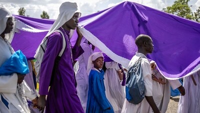 TOPSHOT - Worshippers of the Legio Maria African Church Mission walk in a procession on their way to their Christmas Eve vigil mass in a remote area near Ugunja, on December 24, 2023. Legio Maria is an African independent religious movement that developed gradually and eventually separated from the Roman Catholic Church in the 1960s. The religious movement was initiated by repeated appearances of a mystic woman delivering messages about the incarnation of the Son of God as a black man. (Photo by LUIS TATO / AFP) (AFP) TOPSHOT - Worshippers of the Legio Maria African Church Mission walk in a procession on their way to their Christmas Eve vigil mass in a remote area near Ugunja, on December 24, 2023. Legio Maria is an African independent religious movement that developed gradually and eventually separated from the Roman Catholic Church in the 1960s. The religious movement was initiated by repeated appearances of a mystic woman delivering messages about the incarnation of the Son of God as a black man. (Photo by LUIS TATO / AFP) (AFP)