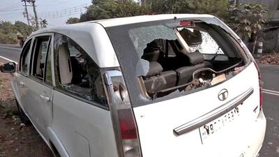 The windows of a vehicle in which a team of the ED was traveling are broken in the attack. (ANI Photo)