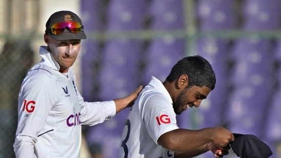 England's Rehan Ahmed, right, is congratulated by teammate Joe Root
