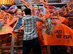 A shopkeeper looks for an order amidst flags and pennants depicting Hindu deities Lord Ram and Hanuman, at a shop in Mumbai. A shopkeeper looks for an order amidst flags and pennants depicting Hindu deities Lord Ram and Hanuman, at a shop in Mumbai.