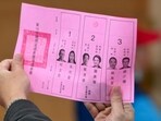 An official of a polling station examines a ballot slip, as vote counting for the presidential election commences. (AFP) An official of a polling station examines a ballot slip, as vote counting for the presidential election commences. (AFP)