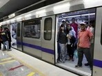 People are seen moving in and out of a Delhi metro train. People are seen moving in and out of a Delhi metro train.
