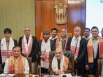 Union Home Minister Amit Shah and Assam Chief Minister Himanta Biswa Sarma with members of United Liberation Front of Asom (ULFA) during signing of a peace accord between ULFA and the central and Assam governments, in New Delhi, Friday. (PTI)