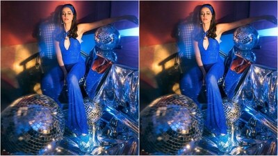Her shimmery blue jumpsuit is from the clothing brand Itrh and features a halterneck line, shimmery fabric, a seductive cutout pattern at the bust, a figure-hugging fit and flared bottoms that add a retro vibe to her look. (Instagram/@ananyapanday) Her shimmery blue jumpsuit is from the clothing brand Itrh and features a halterneck line, shimmery fabric, a seductive cutout pattern at the bust, a figure-hugging fit and flared bottoms that add a retro vibe to her look. (Instagram/@ananyapanday)