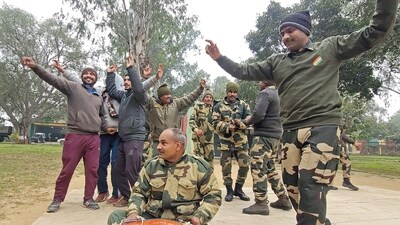 Border Security Force personnel join local residents in celebrating Lohri at the India-Pakistan international border in the Samba sector on Friday. (ANI)